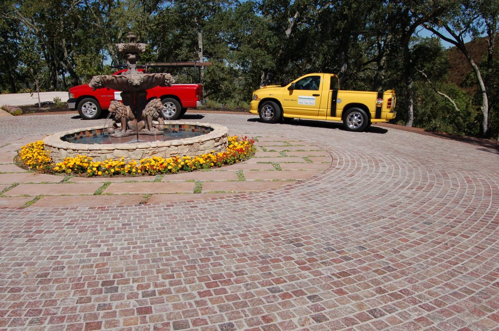 Alamo, CA The finished entranceway with the flowers around the fountain and the grass in the sandstone slab joints.